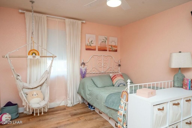 bedroom featuring a ceiling fan and wood finished floors