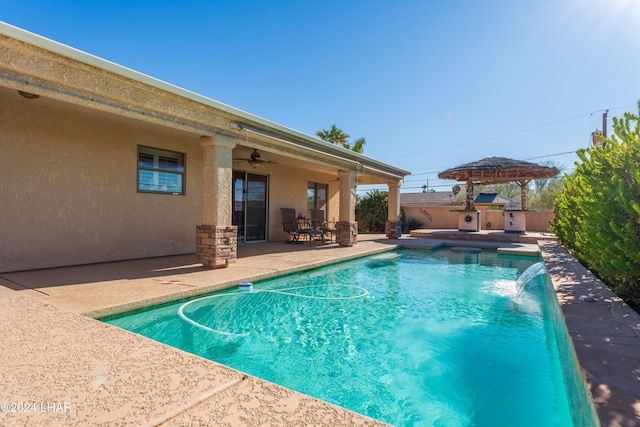 view of pool with a fenced in pool, a patio area, fence, and a ceiling fan