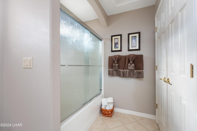 bathroom featuring baseboards, combined bath / shower with glass door, beamed ceiling, and tile patterned floors