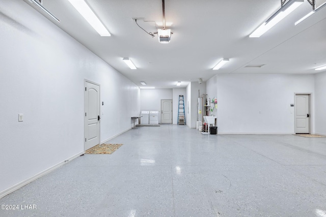 garage featuring a garage door opener and water heater