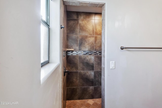 bathroom with a tile shower