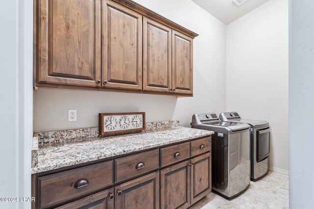 washroom featuring cabinets and washer and dryer