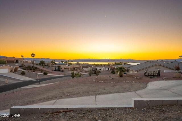 yard at dusk featuring a mountain view