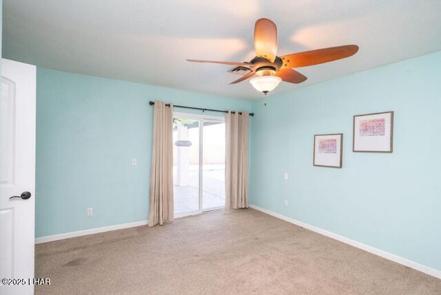 spare room featuring light carpet and ceiling fan