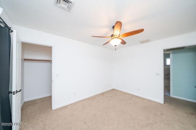 unfurnished bedroom featuring light colored carpet, a closet, and ceiling fan