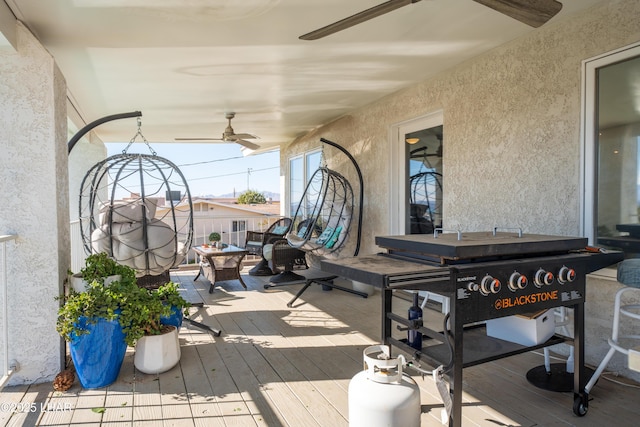 wooden deck featuring ceiling fan