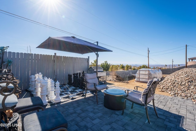 view of patio featuring an outbuilding