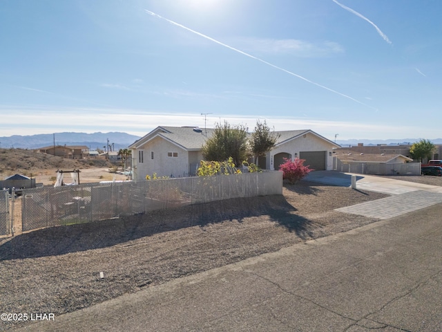 view of front of property featuring a garage and a mountain view