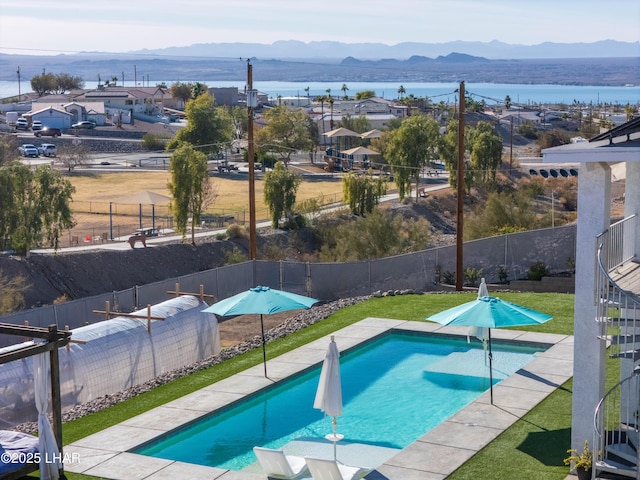 view of swimming pool featuring a water and mountain view