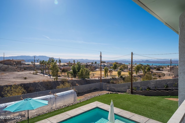 view of pool featuring a mountain view and a yard