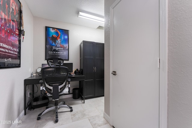 tiled home office featuring a textured ceiling