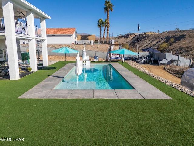 view of pool with a yard and a patio