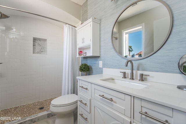 bathroom featuring vanity, a shower with shower curtain, and toilet