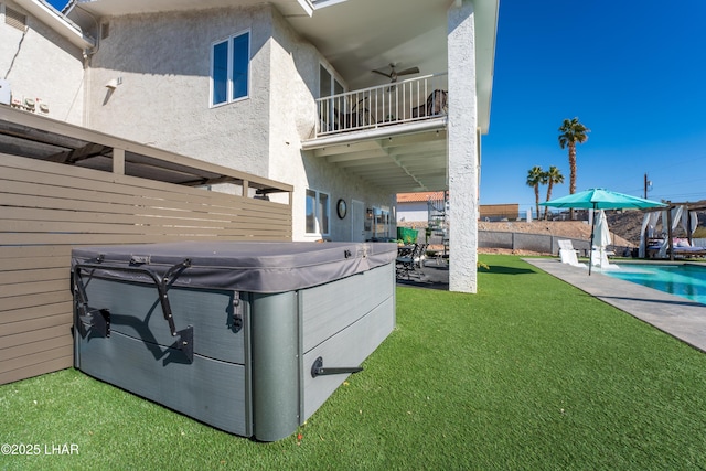 view of yard featuring a hot tub and ceiling fan