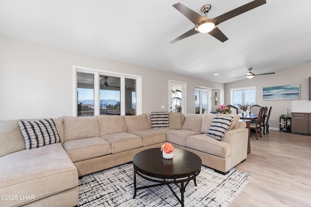 living room with ceiling fan and light wood-type flooring