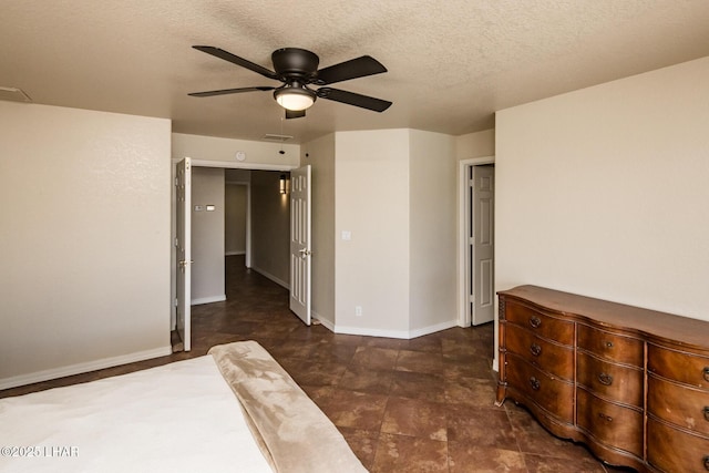 unfurnished bedroom featuring a textured ceiling, a ceiling fan, and baseboards