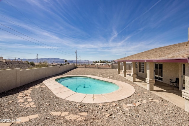 view of pool with a fenced backyard and a patio