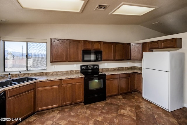 kitchen with vaulted ceiling, black appliances, a sink, and visible vents