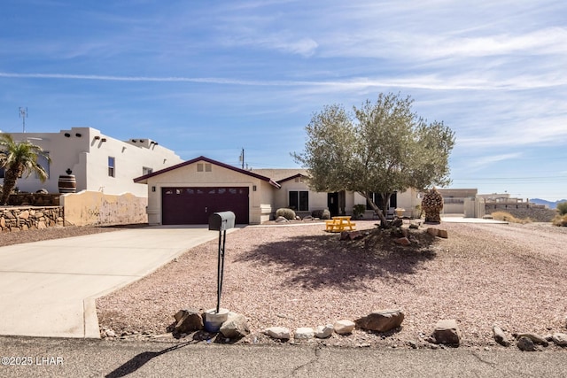 view of front of house with a garage, driveway, central AC, and stucco siding