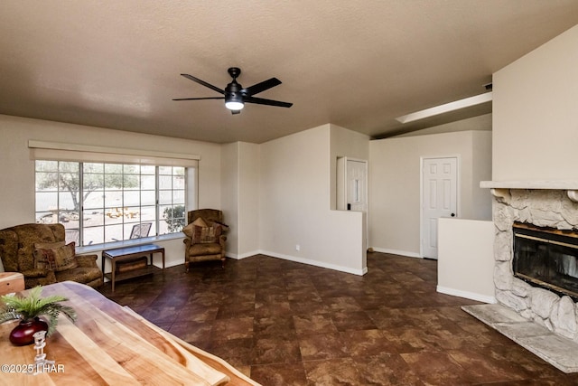 unfurnished living room featuring a fireplace, baseboards, and a ceiling fan