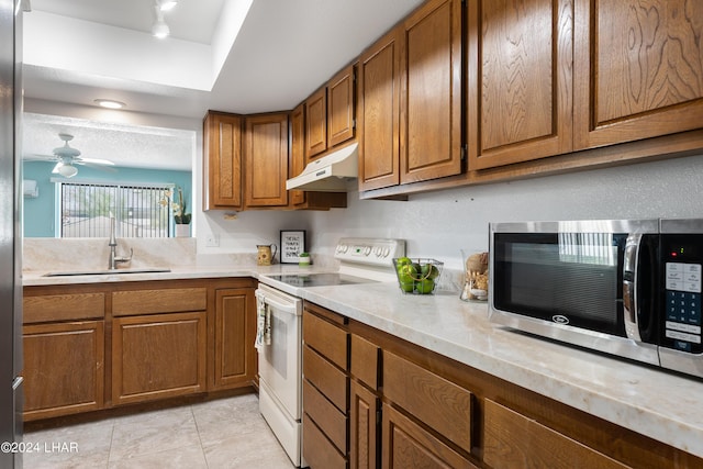 kitchen featuring light tile patterned flooring, sink, ceiling fan, and white range with electric stovetop