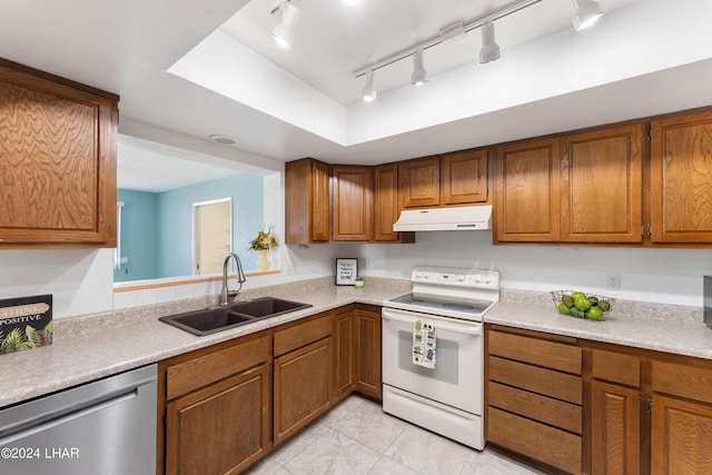 kitchen featuring white range with electric cooktop, sink, stainless steel dishwasher, light tile patterned floors, and a tray ceiling