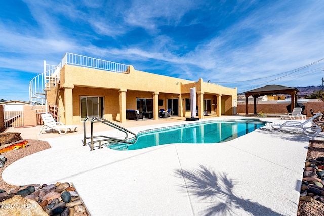 view of pool featuring a gazebo, stairs, a fenced in pool, and a patio