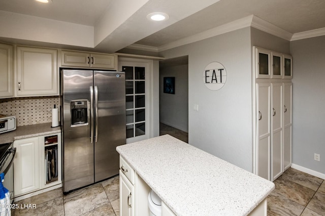 kitchen featuring light stone counters, a kitchen island, stainless steel appliances, ornamental molding, and decorative backsplash