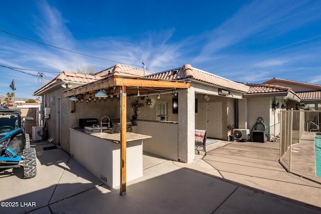 rear view of house with a patio and area for grilling