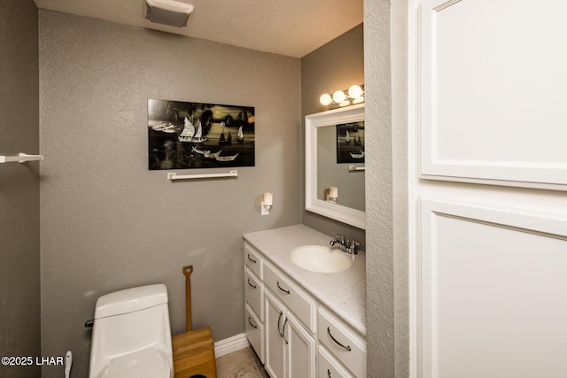 bathroom featuring vanity and toilet