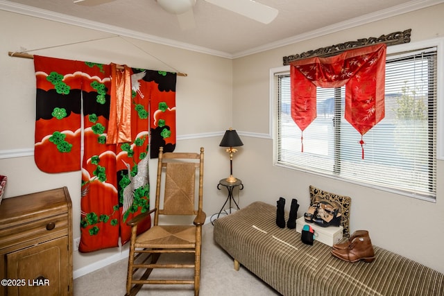 sitting room featuring ceiling fan, plenty of natural light, carpet floors, and crown molding