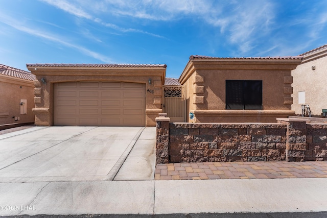 406 Noland Ct, Lake Havasu City, AZ 86403 - view of front facade featuring driveway, stucco siding, a garage, a gate, and a tiled roof