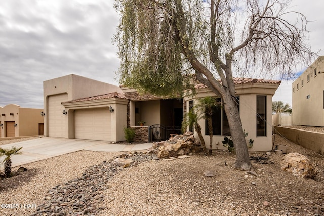 pueblo-style home featuring a garage