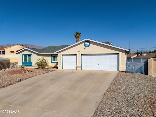 single story home featuring cooling unit and a garage