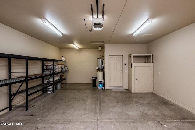 garage with a garage door opener and gas water heater