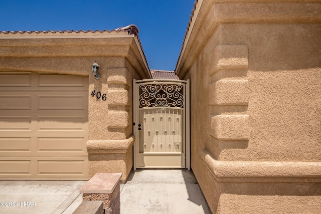 view of exterior entry featuring a tiled roof