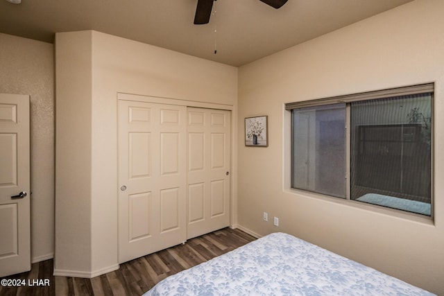 bedroom with dark hardwood / wood-style flooring, a closet, and ceiling fan