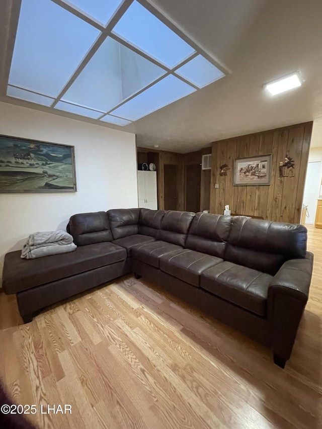 7681 E Robin Hood Rd, Williams, AZ 86046 - living room with light wood-style floors and wood walls