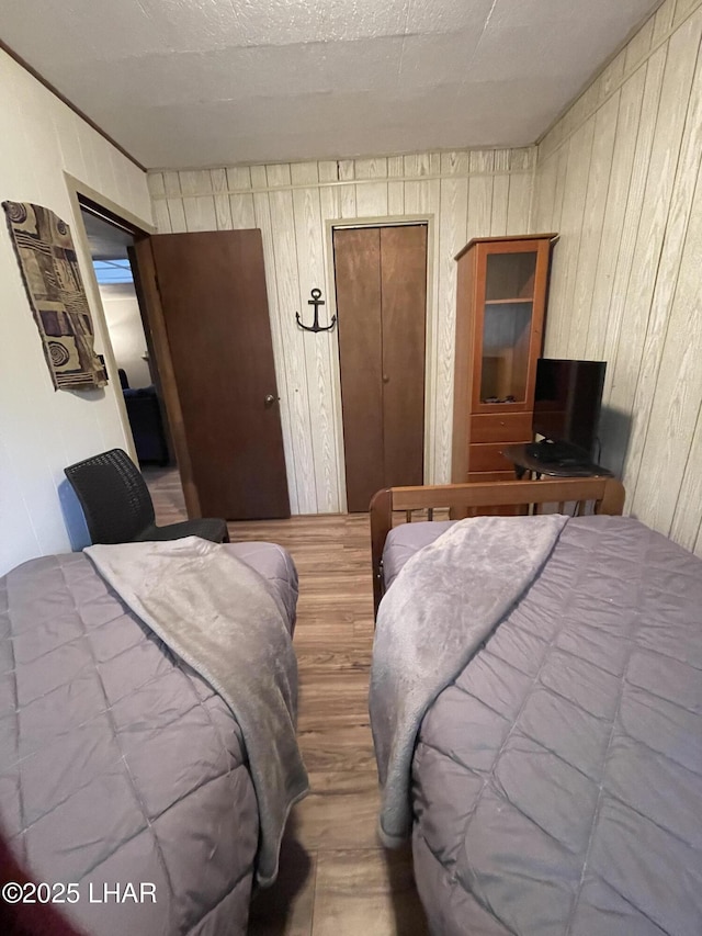 7681 E Robin Hood Rd, Williams, AZ 86046 - bedroom featuring wood finished floors and wooden walls