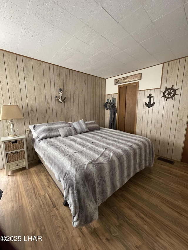 7681 E Robin Hood Rd, Williams, AZ 86046 - bedroom featuring wooden walls and wood finished floors