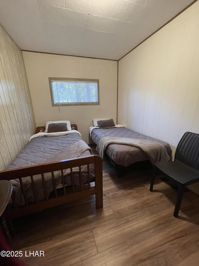 7681 E Robin Hood Rd, Williams, AZ 86046 - bedroom with wood finished floors and wood walls