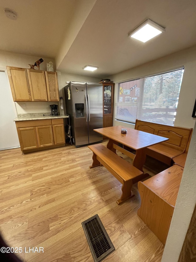7681 E Robin Hood Rd, Williams, AZ 86046 - kitchen with stainless steel fridge with ice dispenser, light wood-type flooring, and light countertops