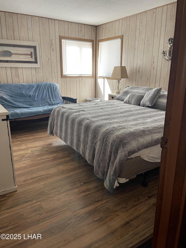7681 E Robin Hood Rd, Williams, AZ 86046 - bedroom with wooden walls and wood finished floors