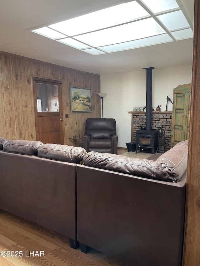 7681 E Robin Hood Rd, Williams, AZ 86046 - living area with wood walls, a wood stove, and wood finished floors