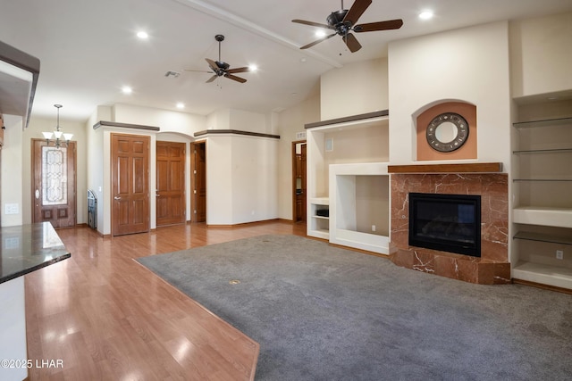 2620 Via Palma, Lake Havasu City, AZ 86406 - unfurnished living room featuring ceiling fan, a high end fireplace, wood finished floors, arched walkways, and recessed lighting