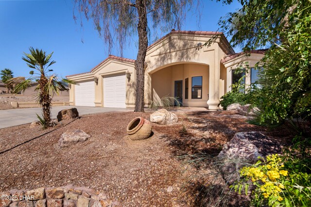 2620 Via Palma, Lake Havasu City, AZ 86406 - mediterranean / spanish-style house with stucco siding, driveway, an attached garage, and a tile roof