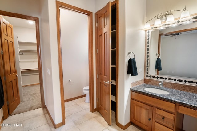 2620 Via Palma, Lake Havasu City, AZ 86406 - bathroom featuring vanity, a walk in closet, a ceiling fan, and tile patterned flooring