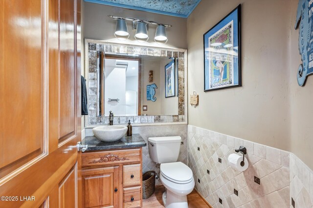 2620 Via Palma, Lake Havasu City, AZ 86406 - half bathroom featuring tile walls, vanity, and a wainscoted wall
