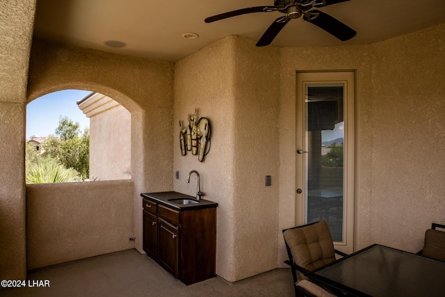 view of patio / terrace featuring sink, a balcony, and ceiling fan