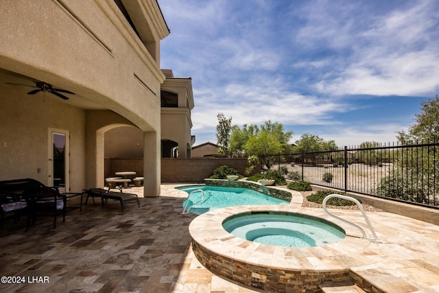 view of swimming pool with an in ground hot tub, ceiling fan, and a patio